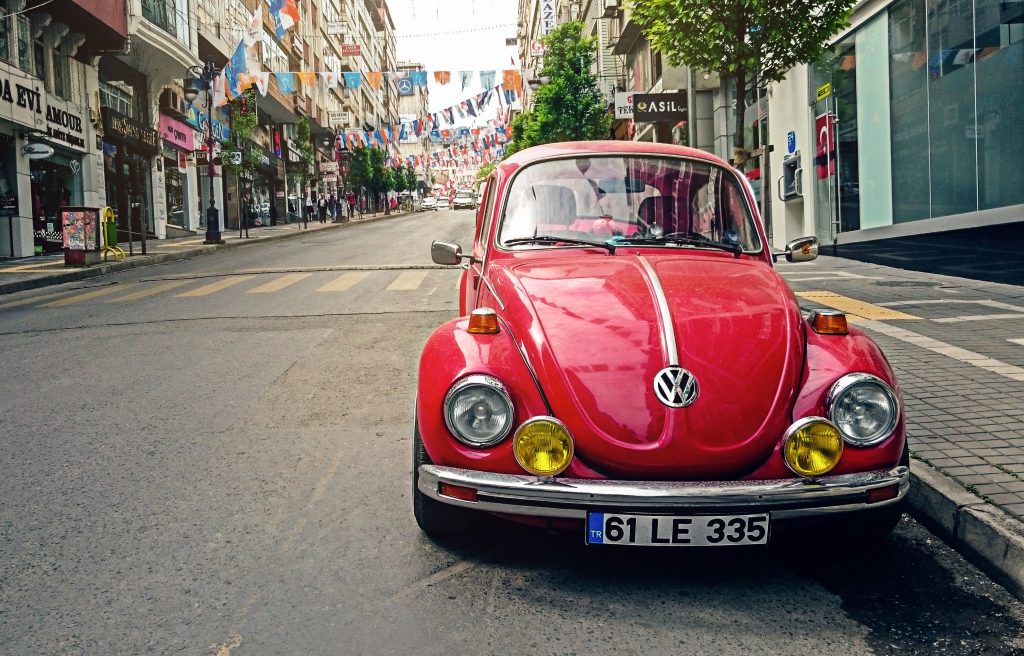 A red VW beetle in an alley