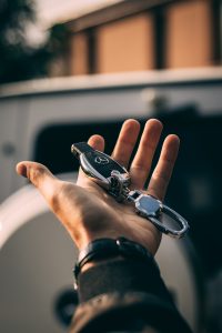 A man holding Mercedes-Benz car keys